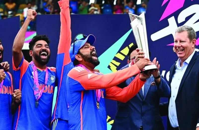 India captain Rohit Sharma receives the ICC T20 World Cup trophy on Saturday. (AFP)