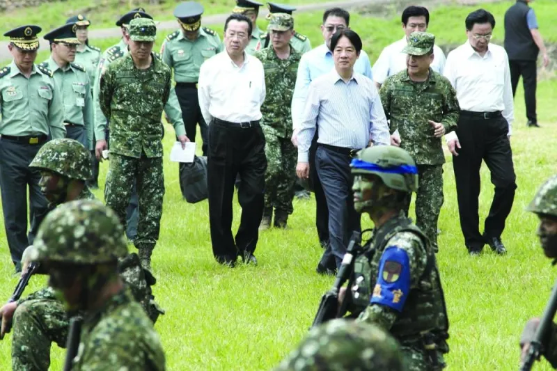 
This picture taken on Friday shows Taiwan’s President Lai (third right) listening to a military official during an inspection of new conscripts at a military base in Taichung. – AFP 