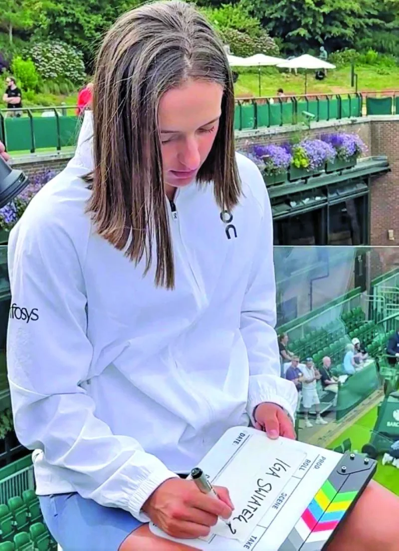 Iga Swiatek of Poland prepares for a TV interview at Wimbledon yesterday. Swiatek, the French Open winner, is the top seed.