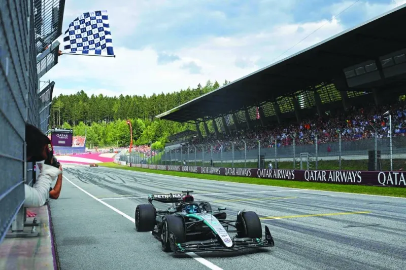 
Mercedes’ British driver George Russell (also inset) crosses the finish line to win the Formula One Austrian Grand Prix on the Red Bull Ring race track in Spielberg, Austria, yesterday. (AFP) 