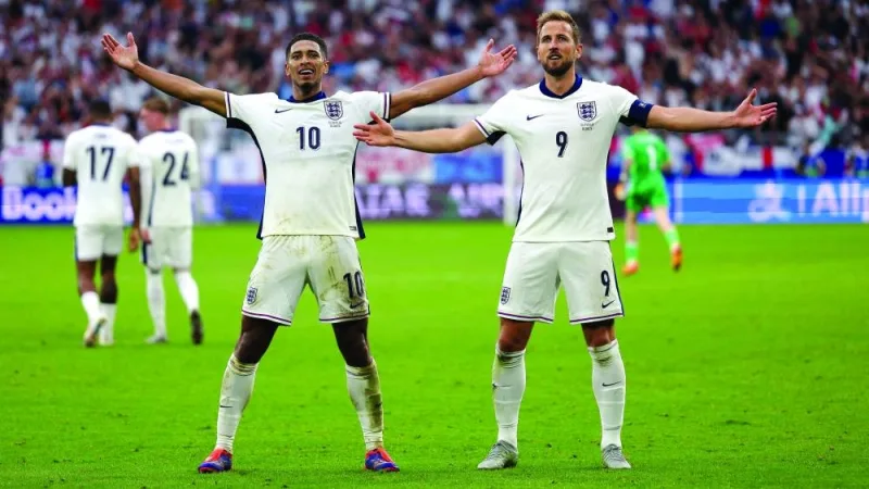England&#039;s midfielder #10 Jude Bellingham celebrates with England&#039;s forward #09 Harry Kane after scoring his team&#039;s first goal during the UEFA Euro 2024 round of 16 football match between England and Slovakia at the Arena AufSchalke in Gelsenkirchen on June 30, 2024. (Photo by Adrian DENNIS / AFP)