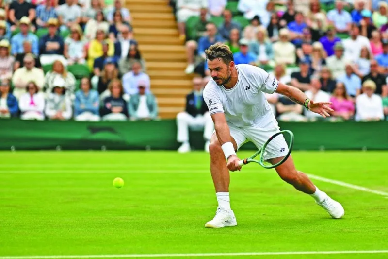 Switzerland&#039;s Stan Wawrinka returns against Britain&#039;s Charles Broom during their singles match on the first day of the 2024 Wimbledon Championships at The All England Lawn Tennis and Croquet Club in Wimbledon, southwest London, on Monday. (AFP)
