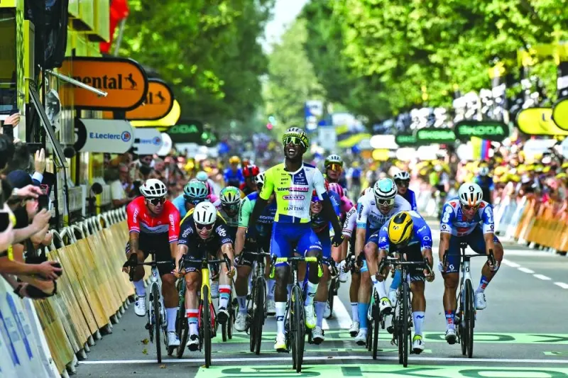 Intermarche - Wanty team’s Eritrean rider Biniam Girmay cycles to the finish line ahead of second-placed Movistar Team’s Colombian rider Fernando Gaviria (second right) and third-placed Lotto Dstny team’s Belgian rider Arnaud De Lie (second left) to win the 3rd stage of the 111th edition of the Tour de France cycling race, 230.5km between Piacenza and Turin, in Italy, on Monday. (AFP)