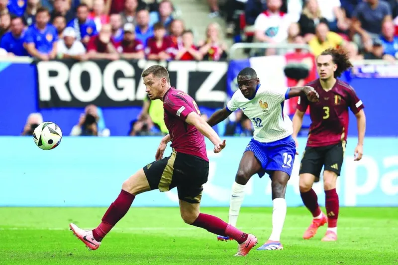 Belgium’s defender Jan Vertonghen (left) deflects a shot from France’s forward Randal Kolo Muani (centre) into goal to give France a 1-0 victory in the UEFA Euro 2024 round of 16 match in Duesseldorf on Monday. (AFP)