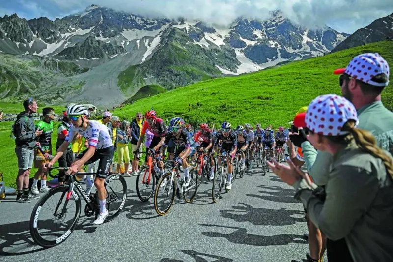 UAE Team Emirates’ Slovenian rider Tadej Pogacar (left) and Red Bull - BORA - hansgrohe team’s Slovenian rider Primoz Roglic (second left) cycle with the pack of riders (peloton) in the Galibier ascent during the 4th stage of the 111th edition of the Tour de France cycling race, 140km between Pinerolo in Italy, and Valloire in France, yesterday. (AFP) 