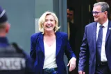 CONTRAST: Former president of the French far-right Rassemblement National parliamentary group Marine Le Pen and RN Mayor of Perpignan Louis Aliot leave the party’s headquarters in Paris yesterday. (AFP)