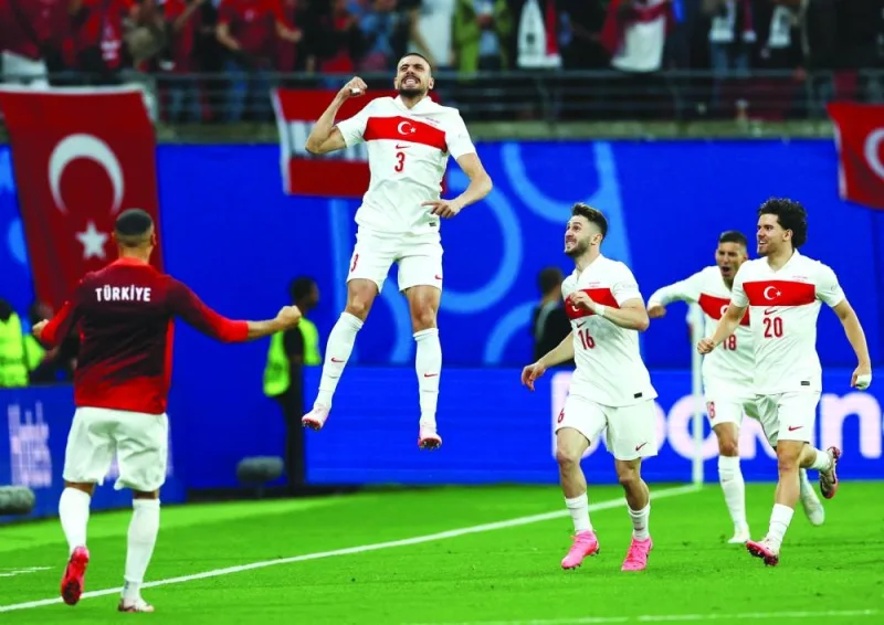 Turkiye’s Merih Demiral celebrates scoring their first goal with teammates Ismail Yuksek and Ferdi Kadioglu during their Euro 2024 round of 16 match against Austria in Leipzig, Germany, yesterday. (Reuters)