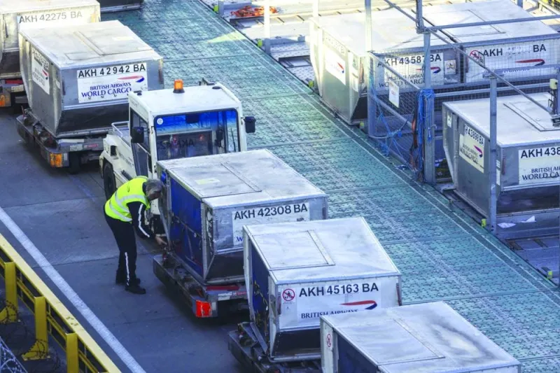 A cargo handler prepares air freight containers for a British Airways flight at Heathrow Airport in London. Global air freight continues to soar great heights lifted by trade growth, booming e-commerce and capacity constraints on maritime shipping.