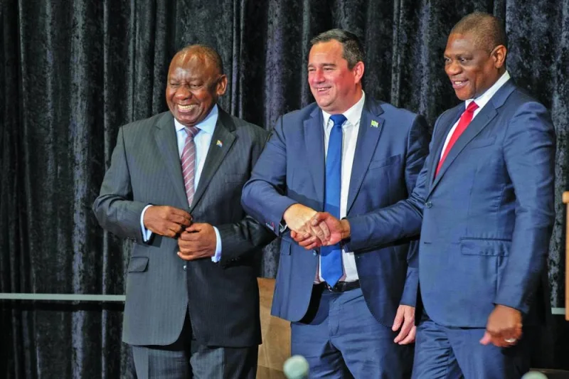 South African President Cyril Ramaphosa smiles as Minister of Agriculture John Steenhuisen (centre) shakes hands with Deputy President Paul Mashatile (right), in Cape Town, on Wednesday.