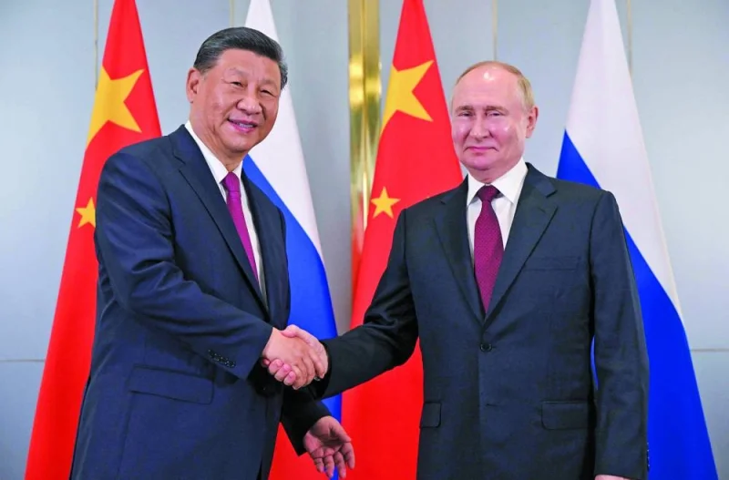 Russian President Vladimir Putin meets with Chinese President Xi Jinping on the sidelines of the Shanghai Co-operation Organisation member states leaders’ summit in Astana on Wednesday. (AFP)