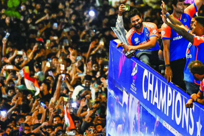 
Indian captain Rohit Sharma holds the trophy as he greets fans in Mumbai. (AFP) 