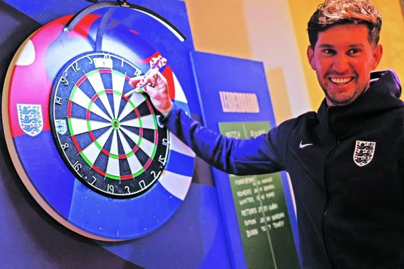 England player John Stones plays darts ahead of a press conference at the team’s base camp, the Weimarer Land golf resort, near Blankenhain, on Thursday. (AFP)
