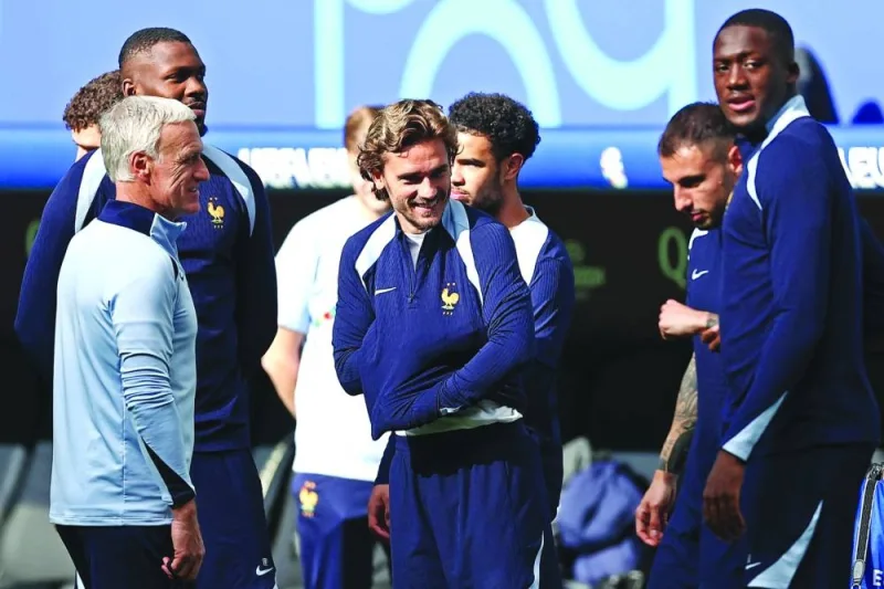 France’s head coach Didier Deschamps, forward Marcus Thuram, midfielders Antoine Griezmann, Warren Zaire-Emery, defenders Jonathan Clauss and Ibrahima Konate during a training session at the Volksparkstadion in Hamburg on Thursday. (AFP)