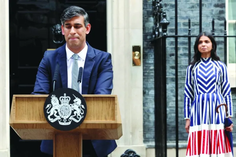 Outgoing Prime Minister Rishi Sunak, flanked by his wife Akshata Murty, delivers a speech at Number 10 Downing Street, following the results of the elections, in London, Britain, on Friday.