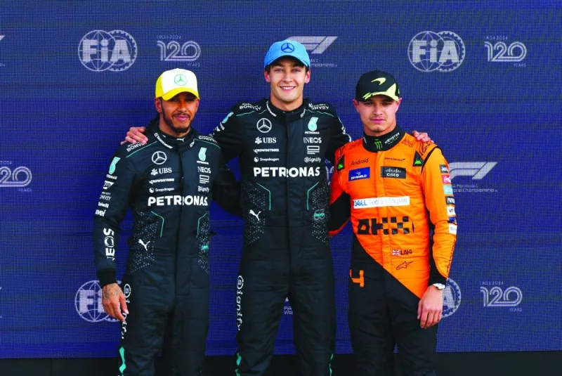 Mercedes’ George Russell (centre) poses after qualifying in pole position with second-placed Mercedes’ Lewis Hamilton and third-placed McLaren’s Lando Norris at Silverstone Circuit on Saturday. (Reuters)