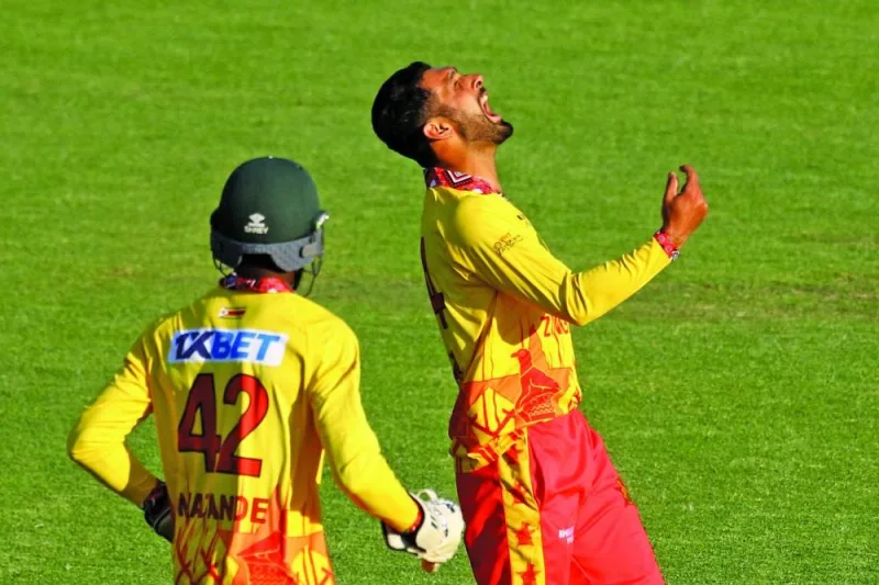 Zimbabwe’s Sikandar Raza (right) celebrates after a dismissal during the first T20I against India at Harare Sports Club in Harare on Saturday. (AFP)