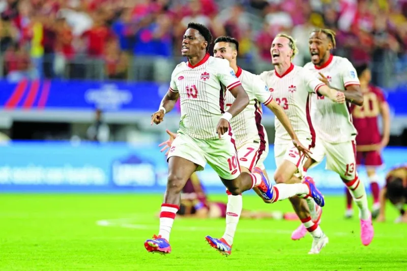 Canada’s forward Jonathan David celebrates alongside teammates their victory after a penalty shoot-out during the Conmebol 2024 Copa America quarter-final against Venezuela at AT&T Stadium in Arlington, Texas, on Saturday. (AFP)