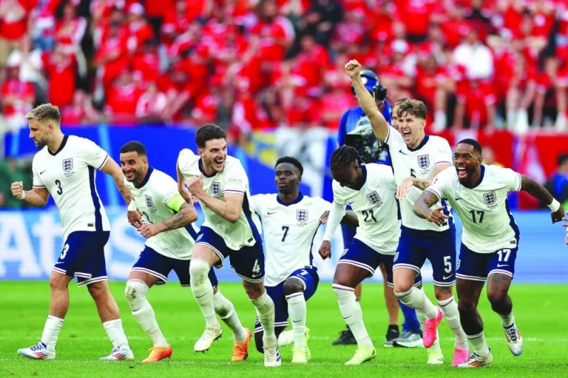 
England’s players celebrate at the end of the penalty shootout as they win the UEFA Euro 2024 quarter-final against Switzerland at the Duesseldorf Arena in Duesseldorf yesterday. (AFP) 