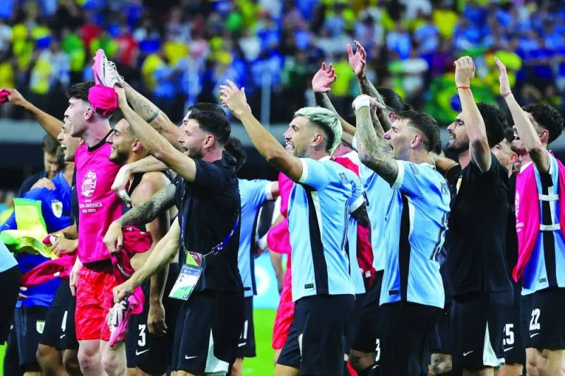 
Players of Uruguay celebrate after winning the CONMEBOL Copa America 2024 quarter-final against Brazil at Allegiant Stadium in Las Vegas, Nevada. (AFP) 