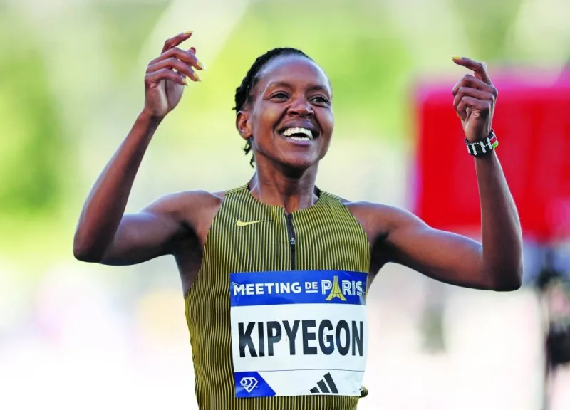 
Kenya’s Faith Kipyegon celebrates after winning the women’s 1,500m to set a new world record at the Paris Diamond League at Stade Charlety in Paris yesterday. (Reuters) 