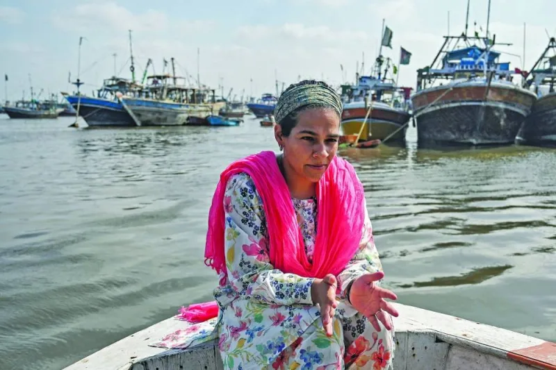 Neha Mankani sits near the shoreline at Baba Island along the Karachi Harbour. (AFP)