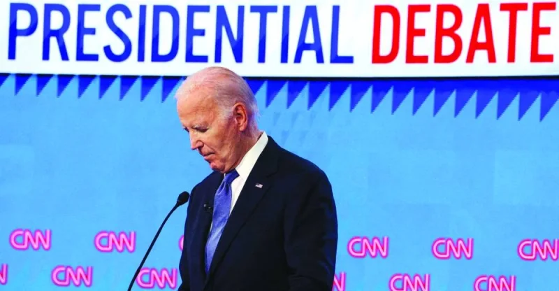 Biden listens as Republican presidential candidate and former US President Donald Trump speaks during their debate on June 27, 2024.