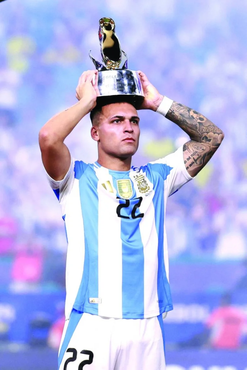 
Lautaro Martinez of Argentina holds the golden boot trophy as top scorer of the tournament. (AFP) 