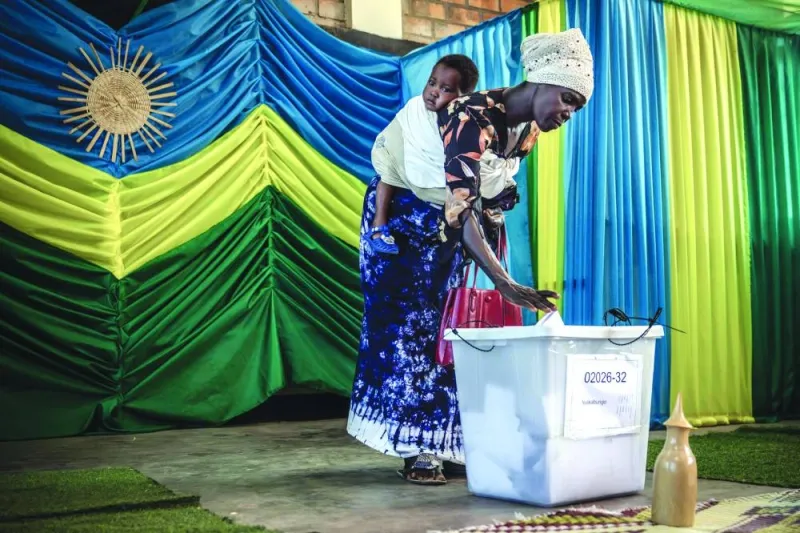 A woman with her baby casts her ballot during the 2024 Rwandan general elections at a polling station in Kigali. – AFP 