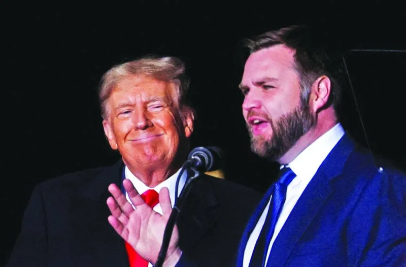 JD Vance speaks as former president Donald Trump smiles at a rally to support Republican candidates ahead of midterm elections, in Dayton, Ohio, on November 7, 2022. (Reuters) 