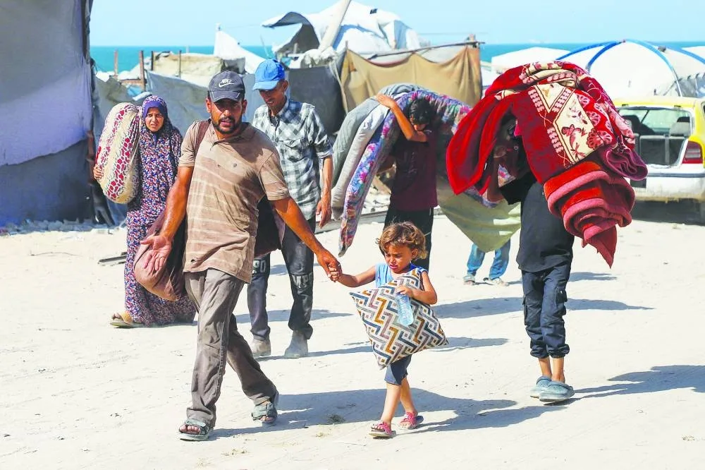 Displaced Palestinians flee amid an Israeli military operation, after Israeli forces ordered residents of Gaza City to evacuate to the south, in Gaza City, yesterday.