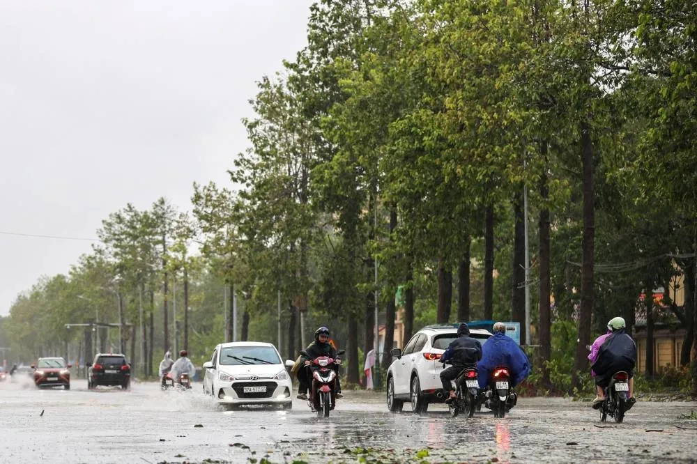 People commute on a flooded street after Typhoon Bualoi makes landfall in Nghe An province, Vietnam, on Monday. REUTERS