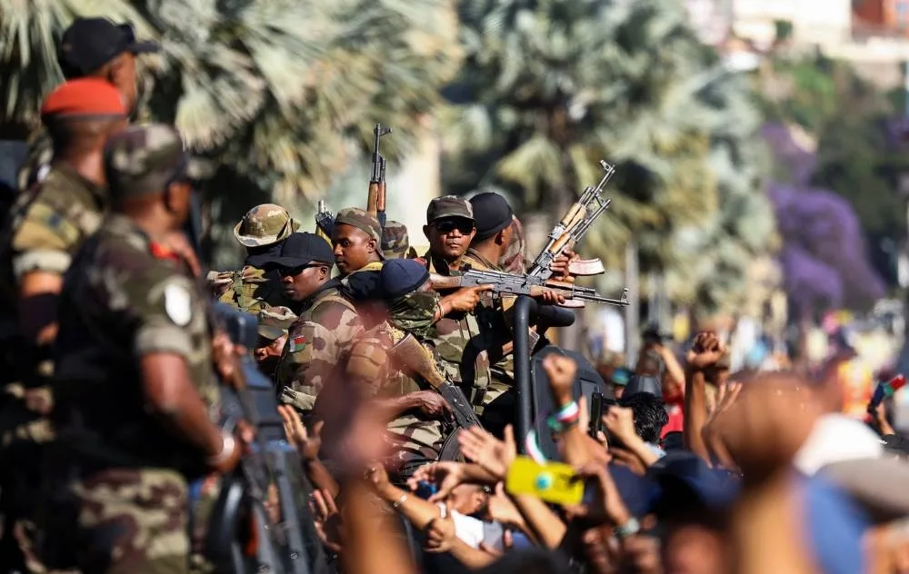 A member of the military looks on as they leave after joining protesters gathered outside the town hall on Independence Avenue during a nationwide youth-led demonstration against frequent power outages and water shortages, in Antananarivo, Madagascar, on Tuesday. REUTERS