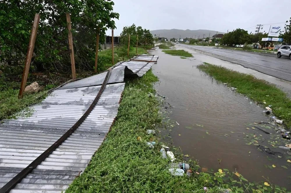 A blown down fence is seen in St. Catherine, Jamaica, on October 28, 2025. Ferocious winds and torrential rain tore into Jamaica Tuesday as Hurricane Melissa made landfall, the worst storm ever to strike the island nation and one of the most powerful hurricanes on record. The extremely violent Category 5 system was still crawling across the Caribbean, promising catastrophic floods and life-threatening conditions as maximum sustained winds reached a staggering 185 miles per hour (295 kilometers per hour). (AFP)