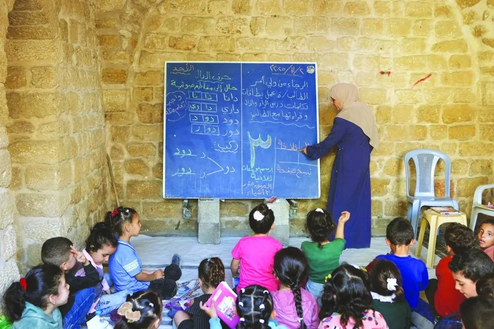 Palestinian children attend a class in the historic "Al-Kamaliya al-Othmanya" school in Gaza City&#039;s Old Town, as part of a volunteer initiative organised by displaced teachers, in Gaza City, yesterday.