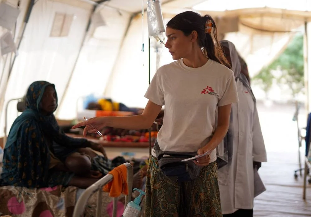 A member of Medecins Sans Frontieres (MSF) counts injured displaced Sudanese people who fled violence in El-Fasher and are receiving treatment at a makeshift clinic run by MSF, in Tawila, North Darfur, on Monday. REUTERS