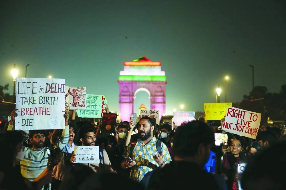 Protesters hold placards in front of the India Gate during a protest against air pollution in New Delhi, India, Sunday.