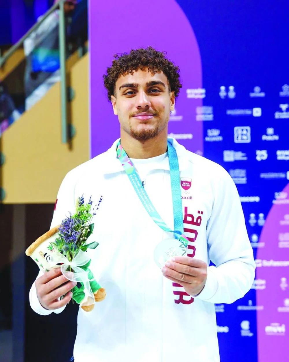 Qatar&#039;s Ali Tamer poses with his silver medal at the Islamic Solidarity Games in Riyadh.