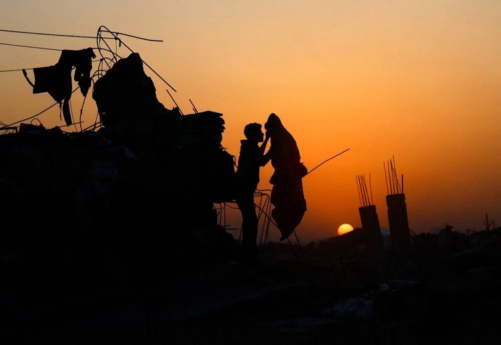 A Palestinian stands among the ruins of buildings, amid a ceasefire between Israel and Hamas, in the northern Gaza Strip November 19, 2025. REUTERS/Mahmoud Issa