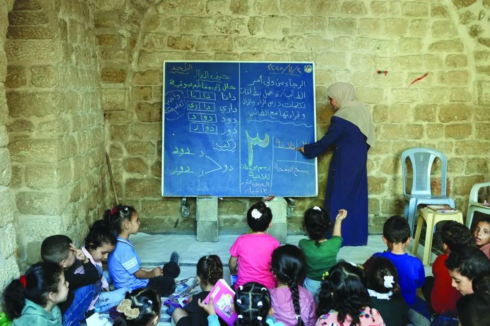File photo shows Palestinian children attend a class in the historic "Al-Kamaliya al-Othmanya" school in Gaza City&#039;s Old Town, as part of a volunteer initiative organised by displaced teachers, in Gaza City.