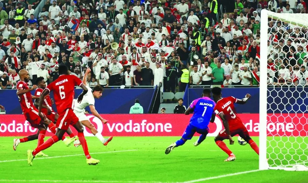 Iraq's Mohanad Ali scores against Sudan at Stadium 974.
