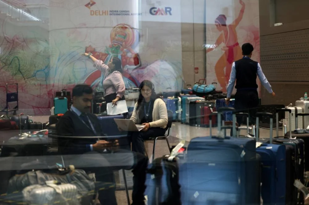 A staff member of IndiGo work to tag stranded bags and belongings of IndiGo passengers following large-scale flight disruptions, at Terminal 1 of Indira Gandhi International Airport in New Delhi, India, December 8, 2025. REUTERS