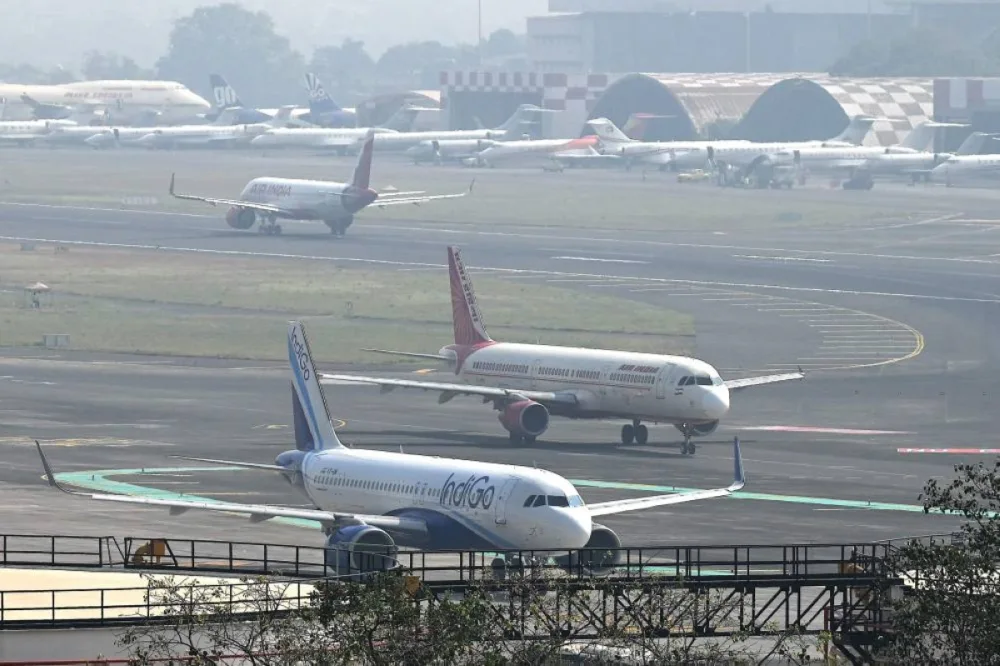 Aircrafts of Indian airlines IndiGo and Air India prepare to takeoff at the Chhatrapati Shivaji Maharaj International Airport in Mumbai on December 8, 2025. (AFP)
