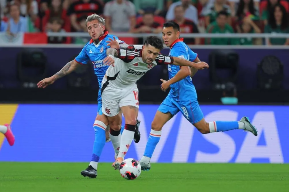 Flamengo&#039;s Giorgian de Arrascaeta #10 (C) is challenged by Cruz Azul&#039;s Gonzalo Piovi #33 (L) and Carlos Rodriguez #19 (R) during the 2025 FIFA Intercontinental Cup match between Cruz Azul and Flamengo at Ahmad Bin Ali Stadium in Doha on December 10, 2025. (AFP)