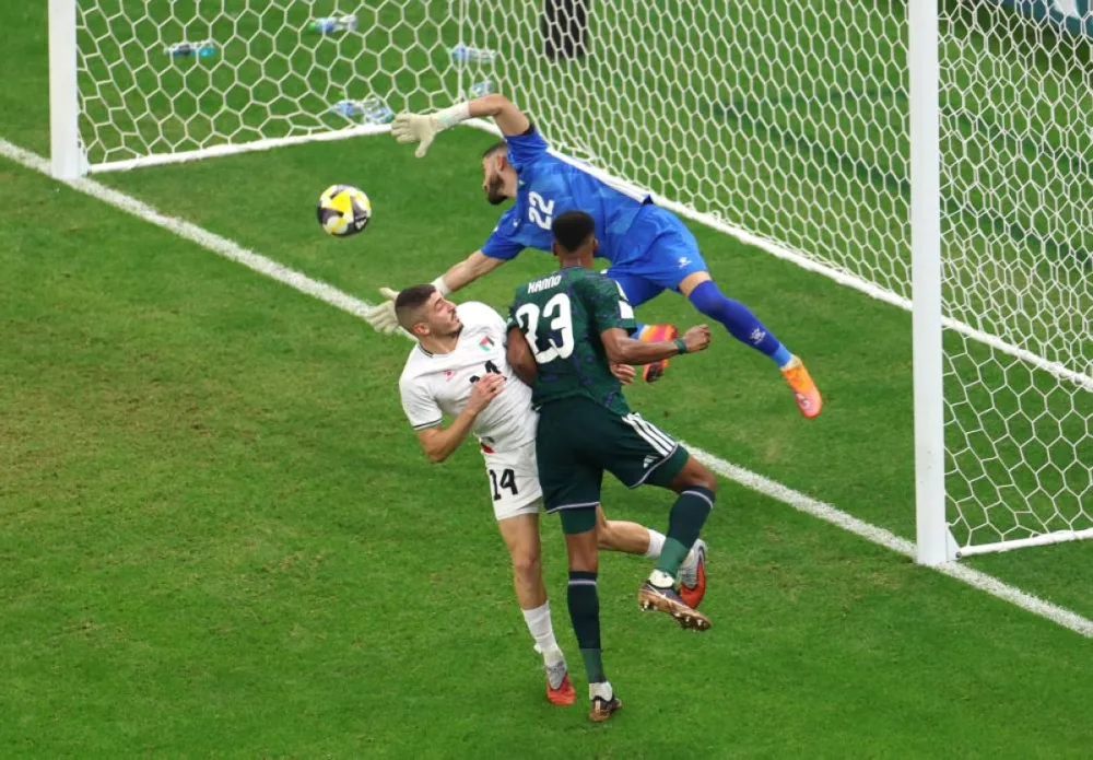 Saudi Arabia's Mohamed Kanno scores their second goal past Palestine's Ikram Rami Hamadeh on Thursday. REUTERS