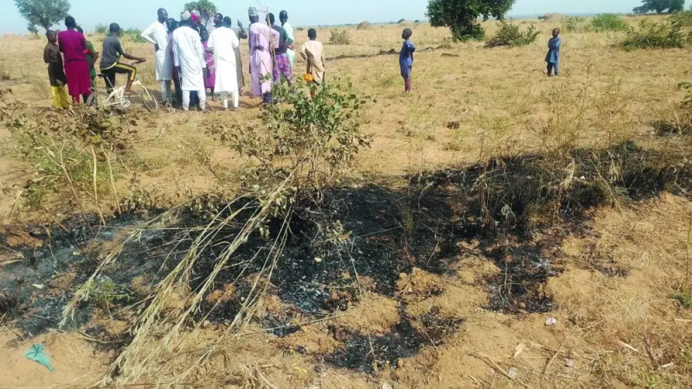 People gather at the site of an airstrike in Jabo Garin Maigari village, after US forces had launched a strike against Islamic State militants in northwest Nigeria at the request of Nigeria's government, in Sokoto, Nigeria, yesterday.
