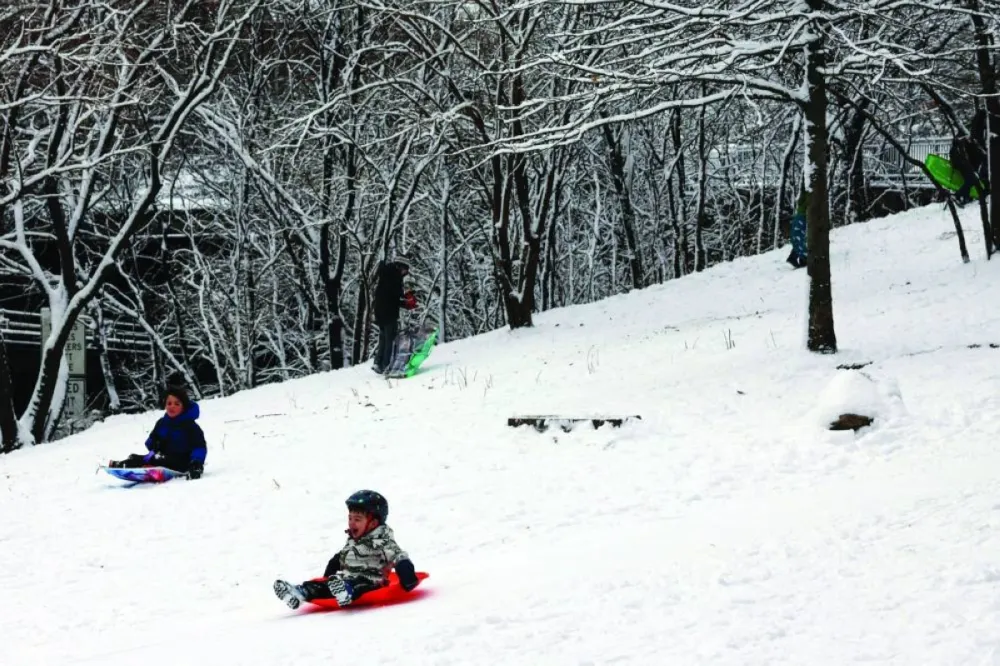 Children sled in a park in the Brooklyn borough of New York City, Saturday.