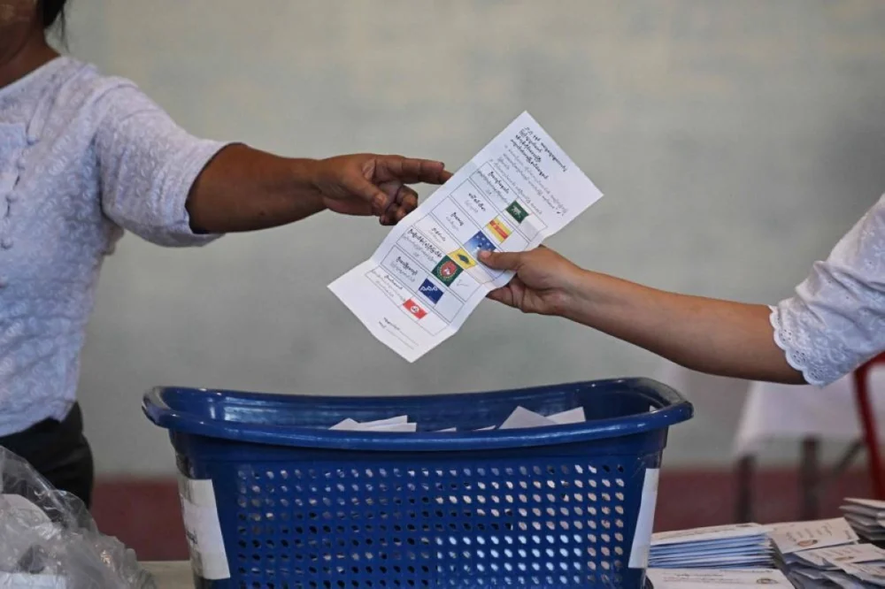 Members of Myanmar’s Union Election commission (UEC) count ballots after the closing of polls at a polling station in the first phase of Myanmar’s general election in Yangon on December 28, 2025. (AFP)