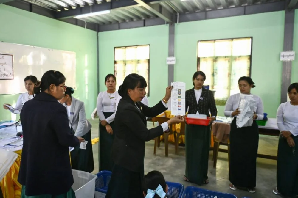 Members of Myanmar’s Union Election commission (UEC) count ballots after the closing of polls at a polling station in the first phase of Myanmar’s general election in Naypyidaw on December 28, 2025. (AFP)