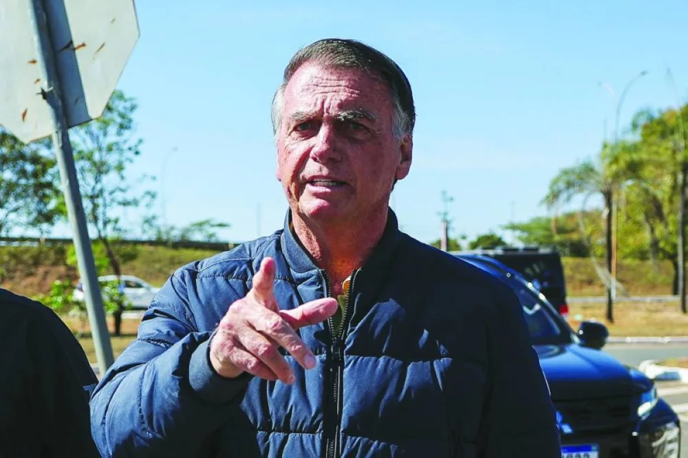 Brazil's former President Jair Bolsonaro gestures as he arrives to the State Secretariat of Penitentiary Administration headquarters in Brasilia, Brazil July 18, 2025. REUTERS
