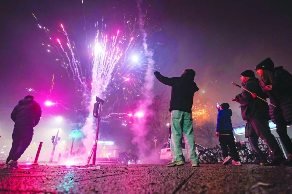 Revellers set off fireworks in the neighbourhood of Schoeneberg to celebrate the New Year, in Berlin. 